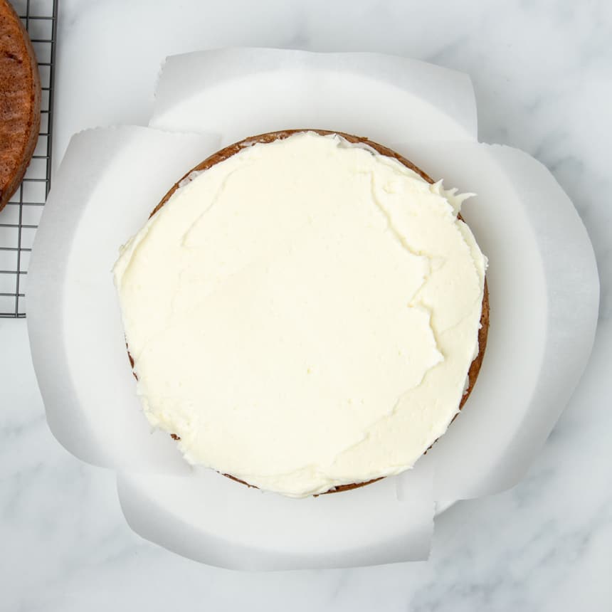 white frosting spread on top of cake