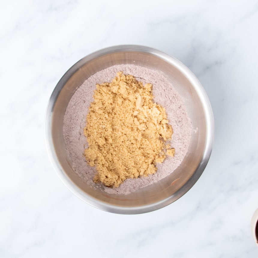 light brown sugar sitting on top of pale brown powder in same mixing bowl