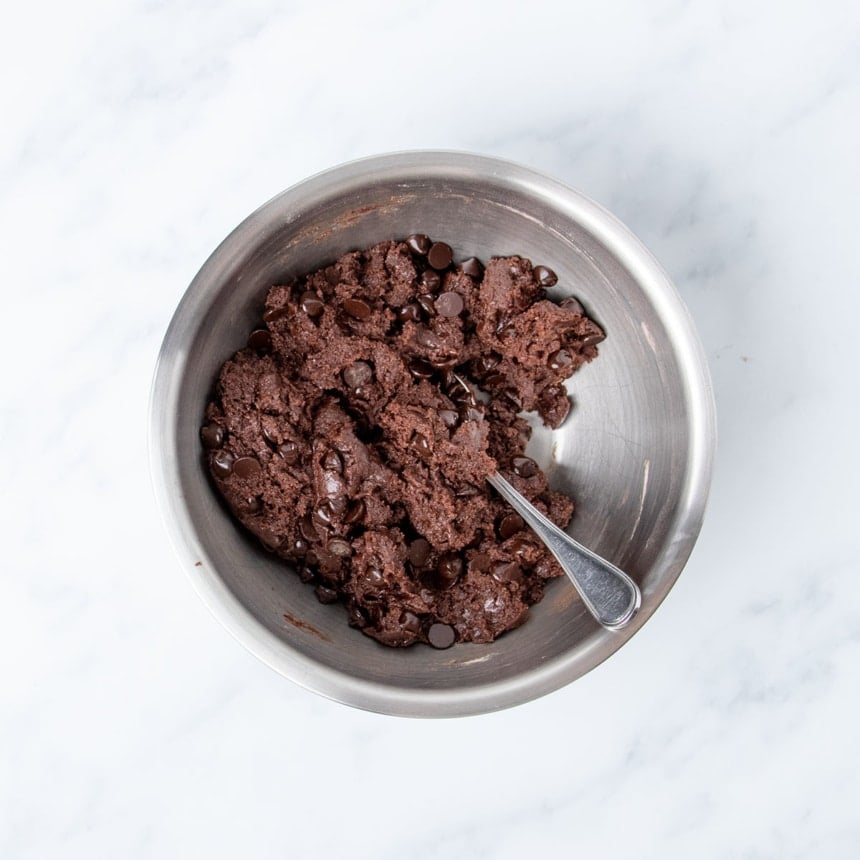 darker brown chocolate chips mixed into dark brown cookie dough