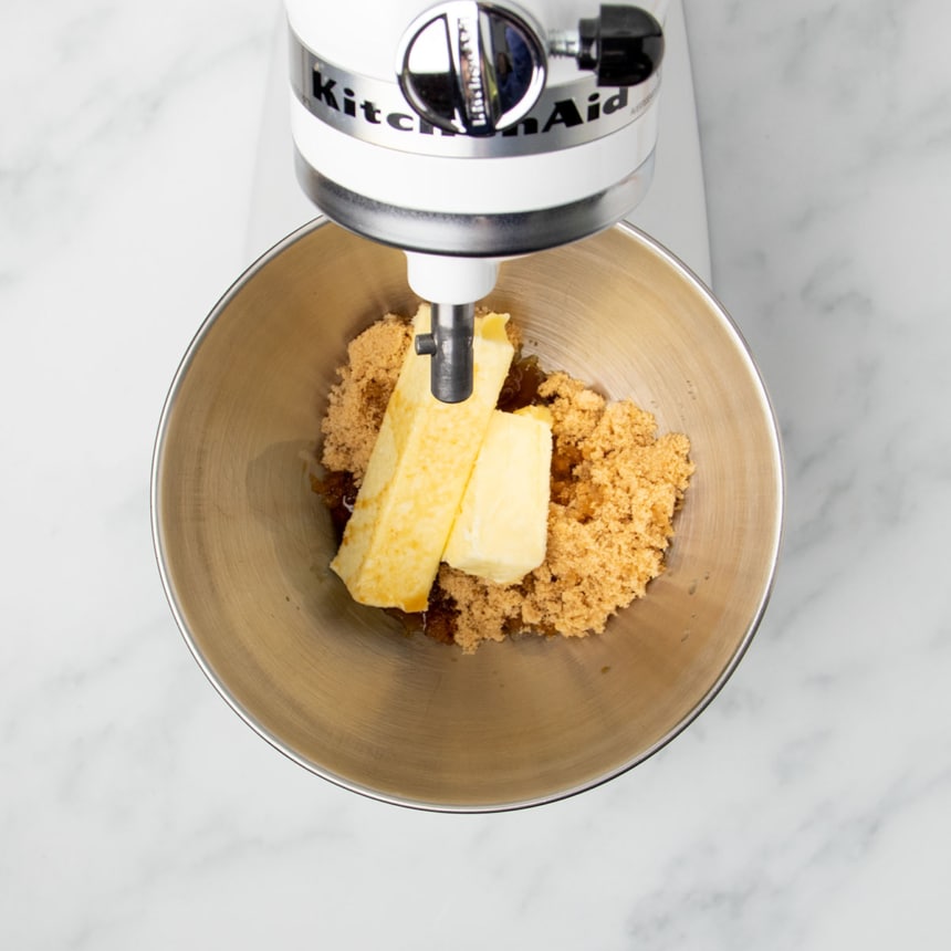 one and one half sticks yellow butter, brown sugar and vanilla in metal KitchenAid mixing bowl