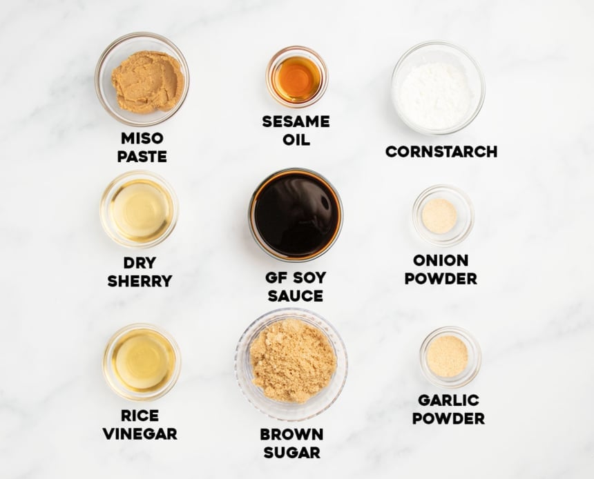 9 gluten free stir fry sauce ingredients in small glass bowls with ingredient names written below each ingredient