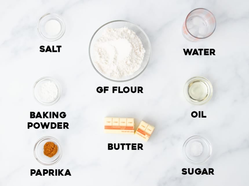 ingredients to make gluten free ritz crackers in small bowls with names of each in bold black type