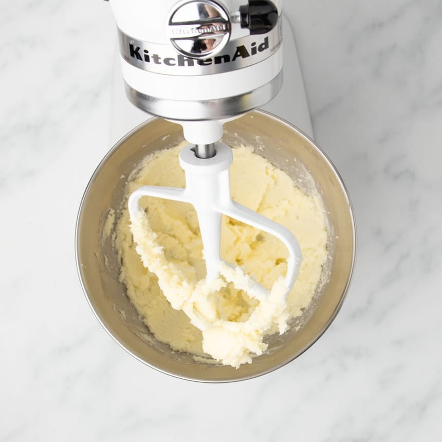 Light yellow mixture of beaten butter, sugar and vanilla in stand mixer with paddle attachment and metal mixing bowl