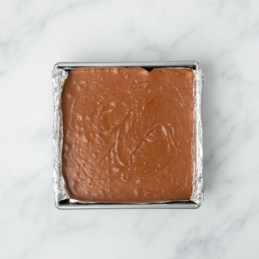 same light brown mixture in single smooth layer in 8-inch square metal baking pan lined with nonstick aluminum foil