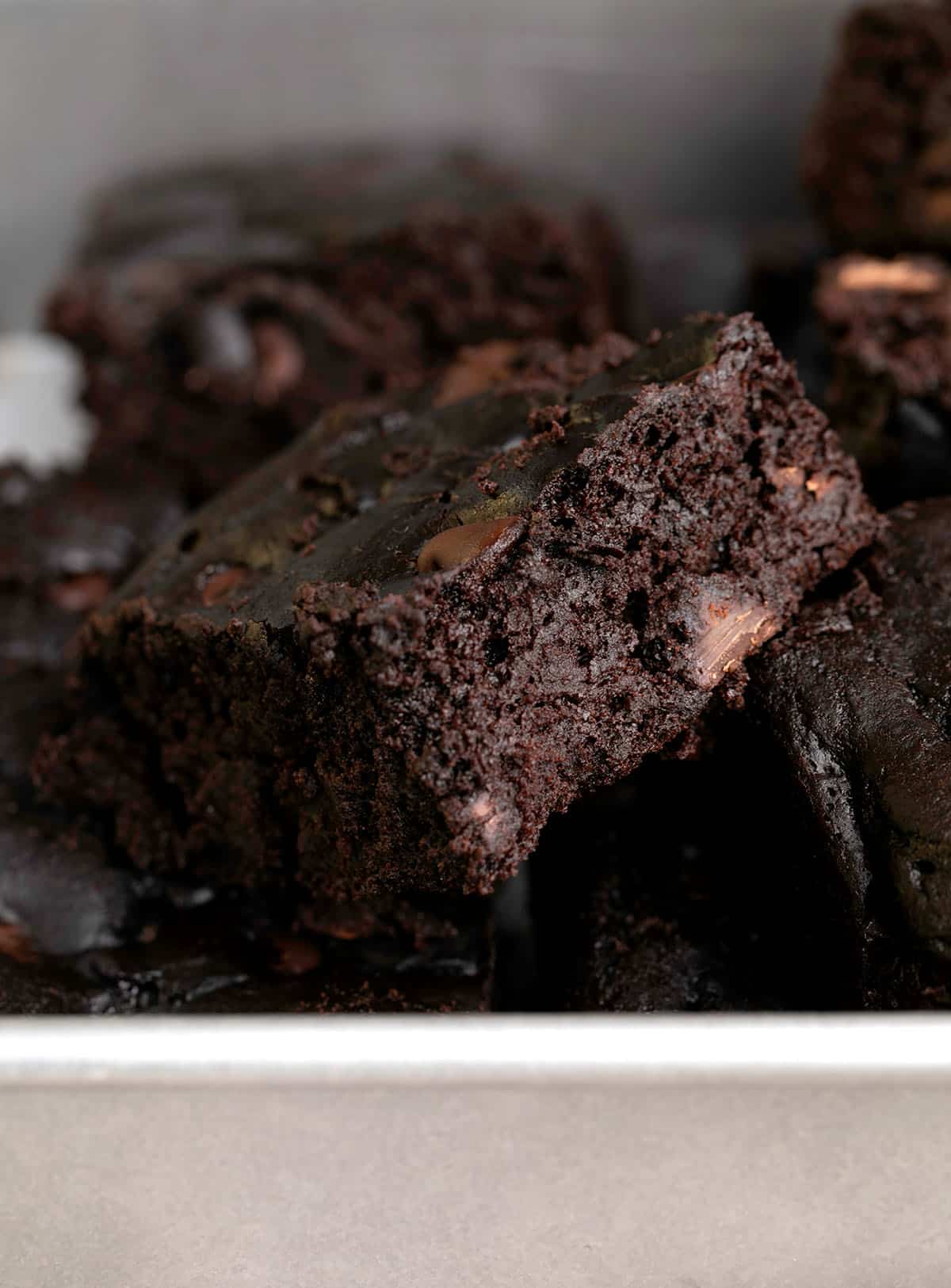 Black bean brownies in a pile in a metal baking pan