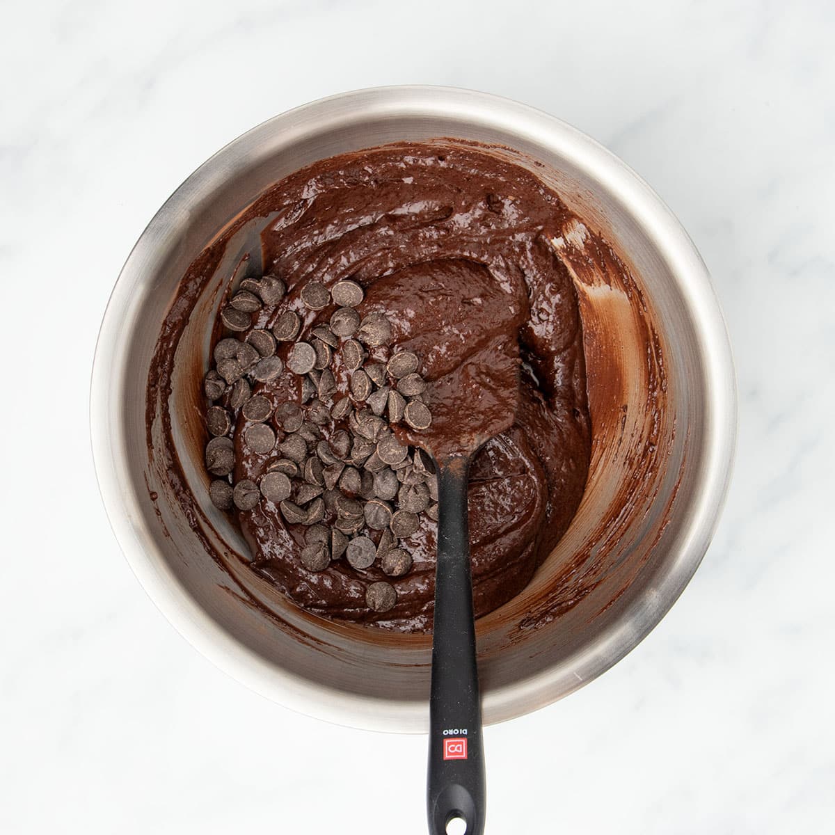 Same brownie mixture with chocolate chips sitting on top. 