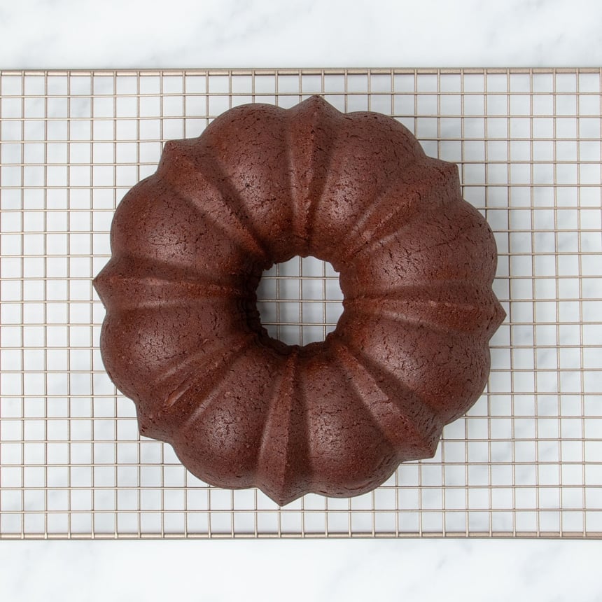 underside of chocolate brown cake overturned onto wire rack, pan removed