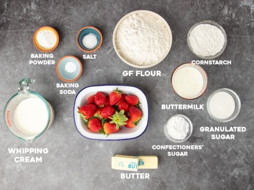 ingredients for gluten free strawberry shortcakes with white block letters with names of ingredients