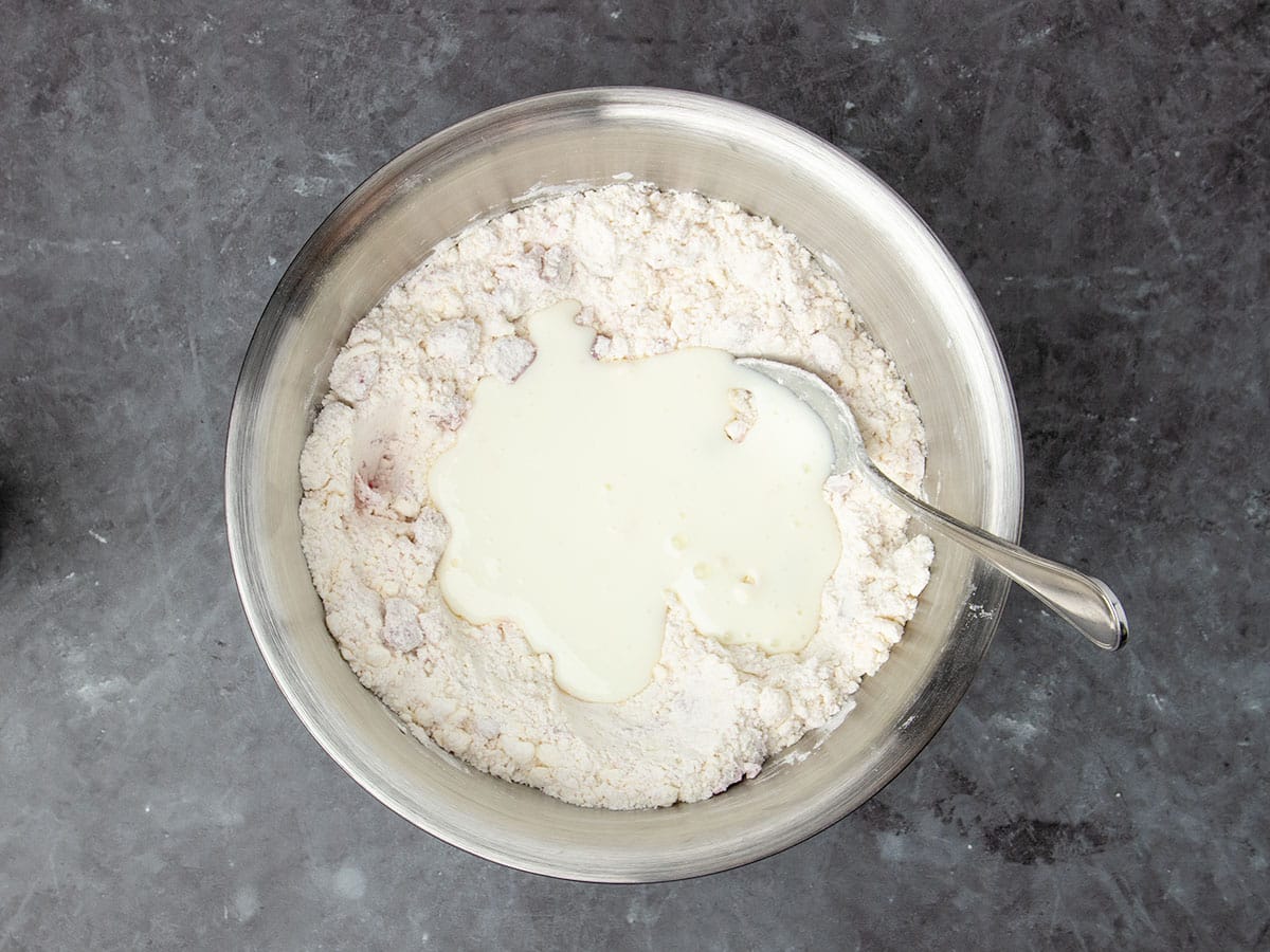 mixture in same bowl with white liquid buttermilk on top