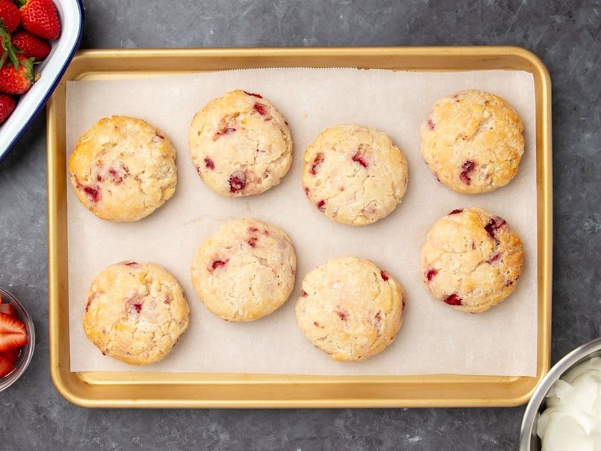 same biscuits on same baking sheet on white paper after biscuits have been baked and are lightly golden brown