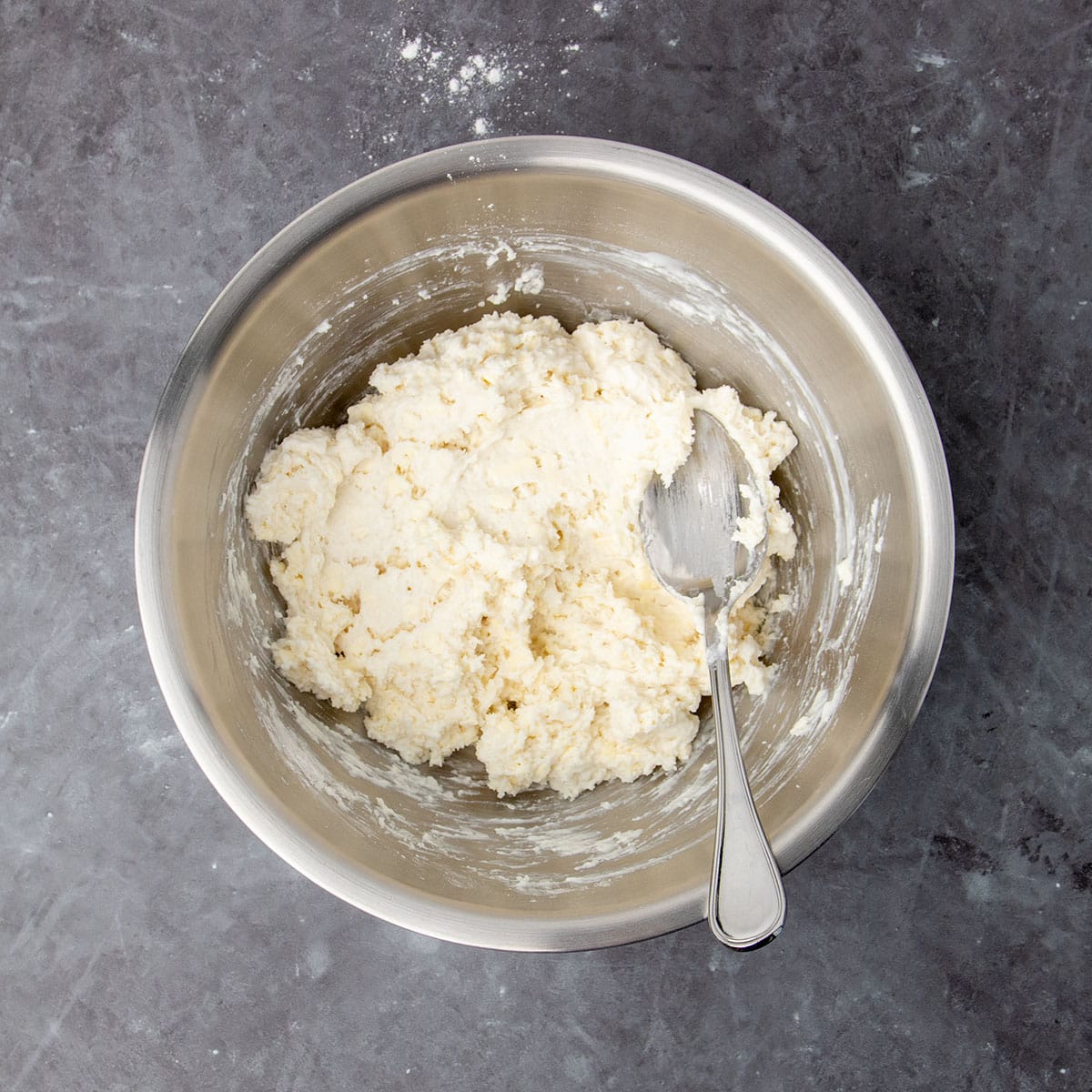 same mixing bowl with soft, craggy topping mixture after buttermilk was mixed in