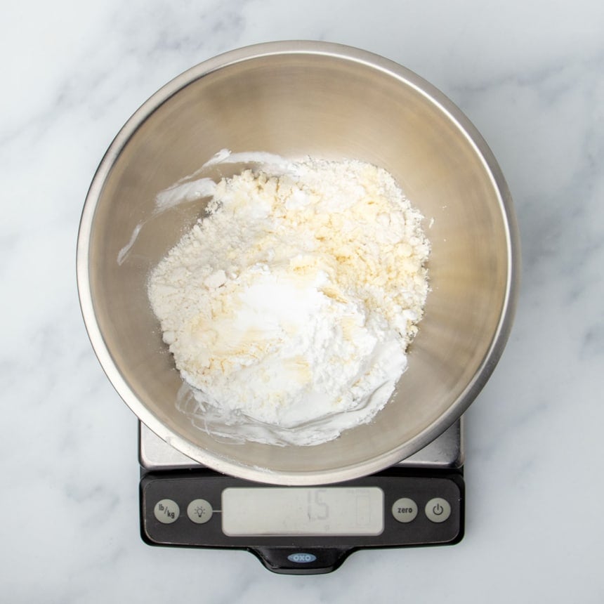same bowl with more starch white powder on top on the same scale reading 15 grams