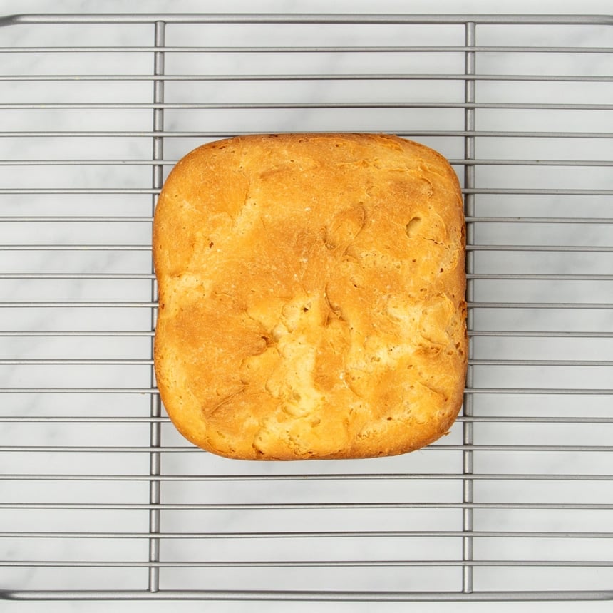 image of top of bread machine bread on wire silver metal rack