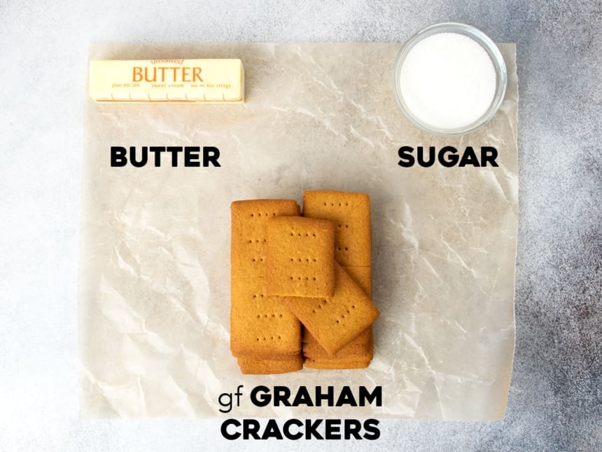 3 ingredients for gluten free graham cracker crust on wax paper with names of each ingredient in black block lettering below it