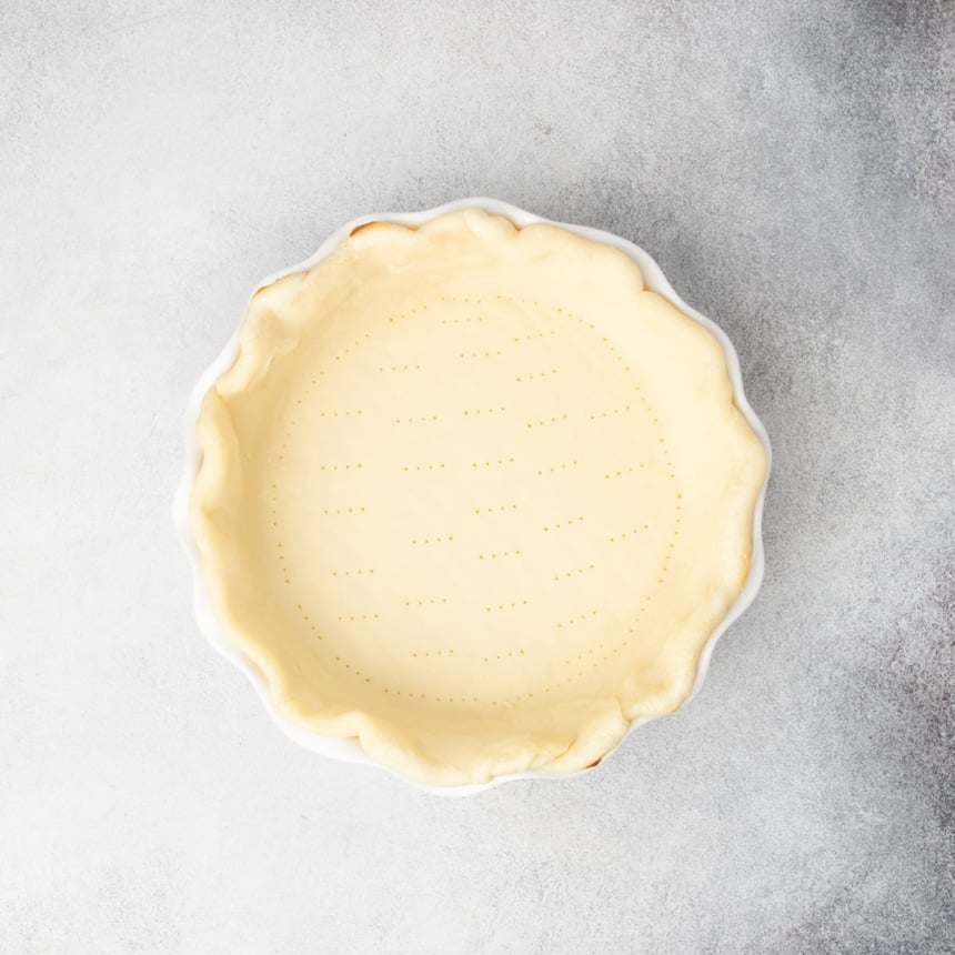 same pie crust now lightly parbaked with some golden edges