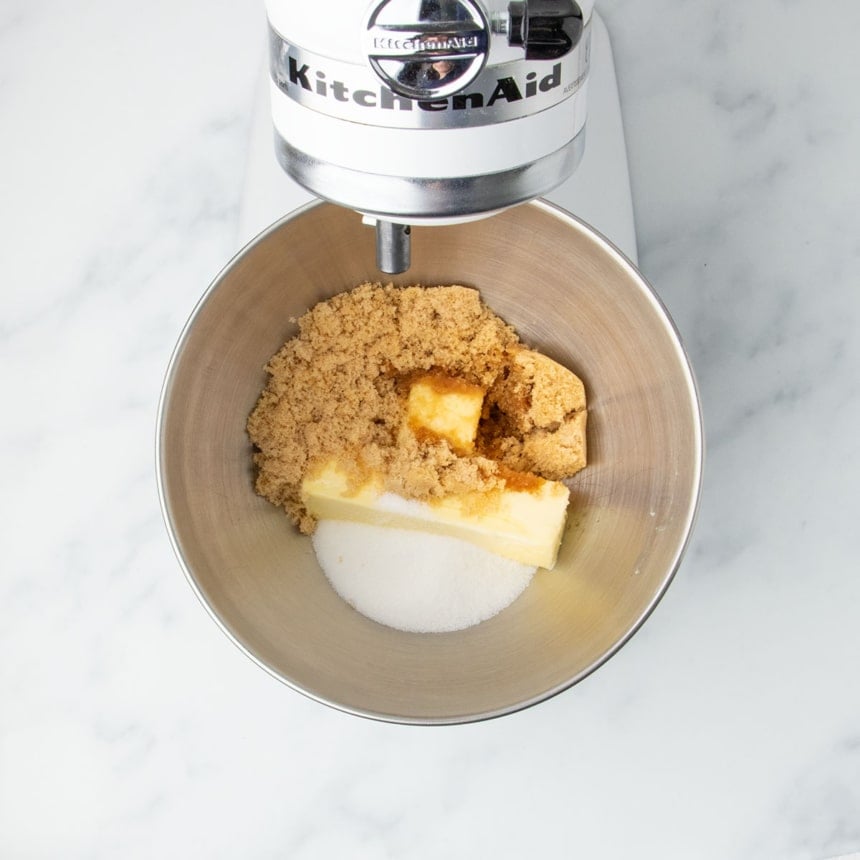 Butter, sugars, and vanilla extract in a stand mixer bowl before creaming.