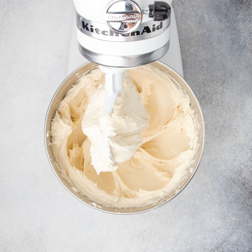 Gluten free dinner roll dough being mixed in a stand mixer until smooth and fluffy.