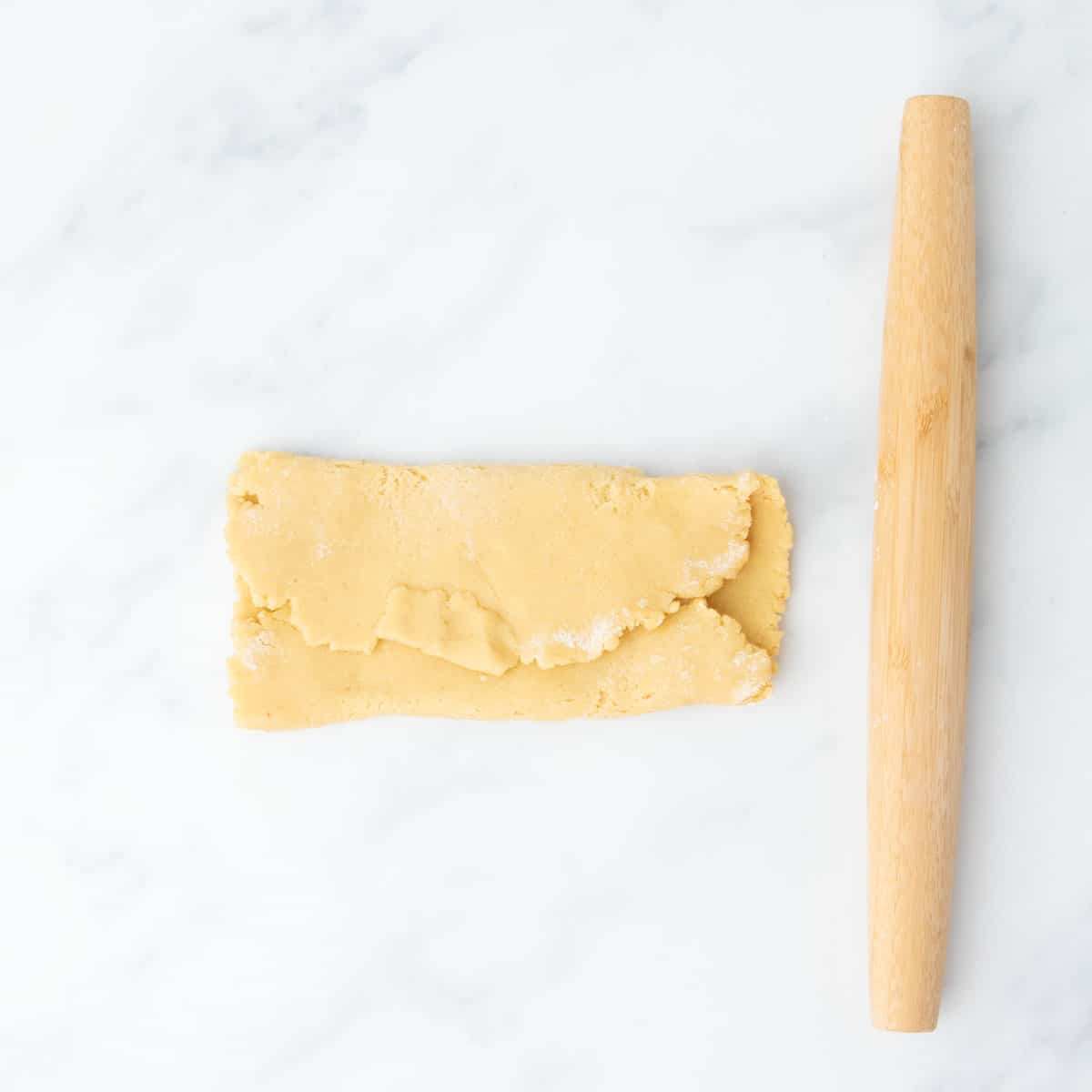 Dough folded into thirds over itself, showing a lamination step.