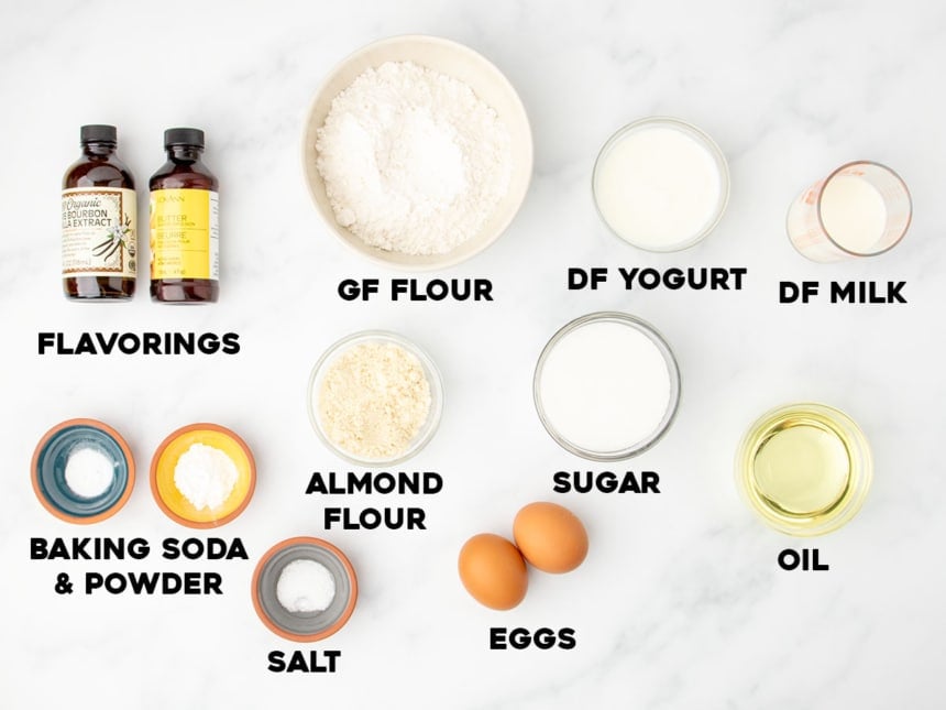 Labeled ingredients for making dairy free gluten free cake, including flours, sugar, and nondairy milk.