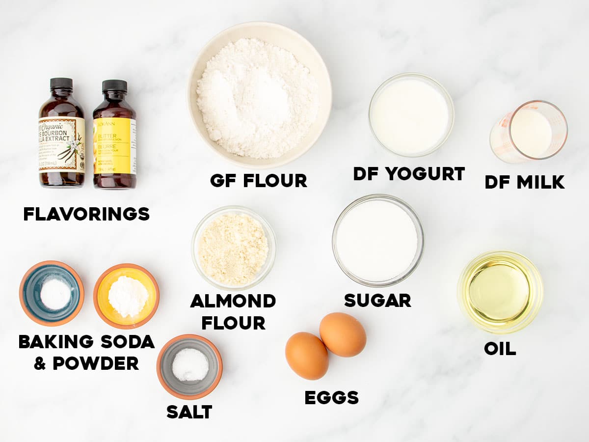 Labeled ingredients for making dairy free gluten free cake, including flours, sugar, and nondairy milk.
