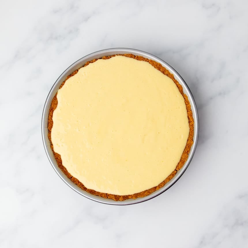Unbaked gluten free lemon pie filling spread evenly in the cookie crust before baking