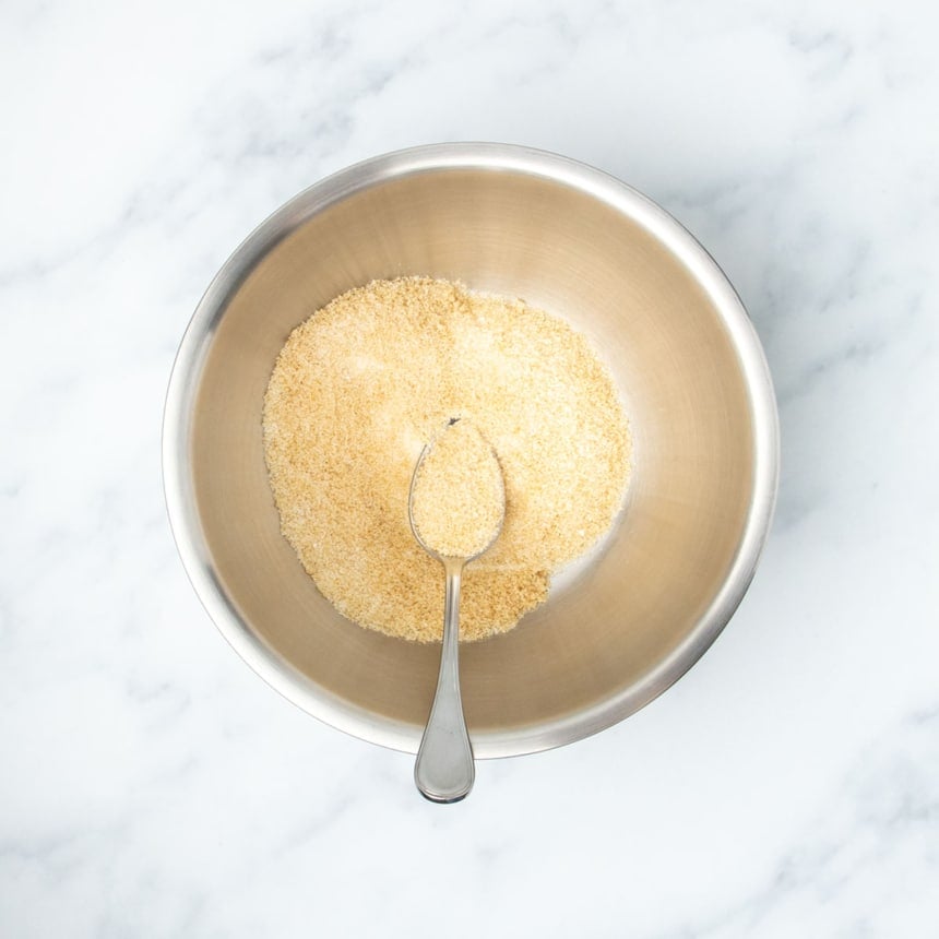 Granulated sugar and brown sugar mixed together in a large metal mixing bowl, ready to begin the batter.