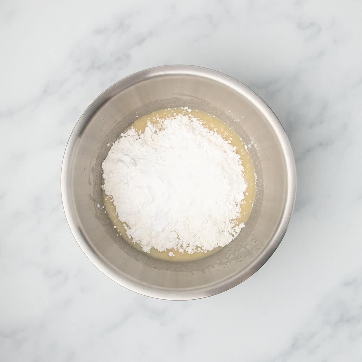 Gluten free flour, starch, baking powder, baking soda and salt added to the wet mixture in the same bowl.