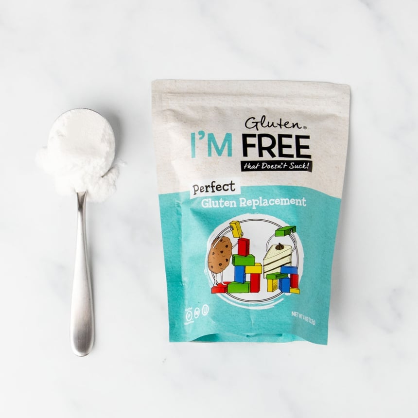 bright blue and white package of perfect gluten replacement with sample of white powder on large metal spoon
