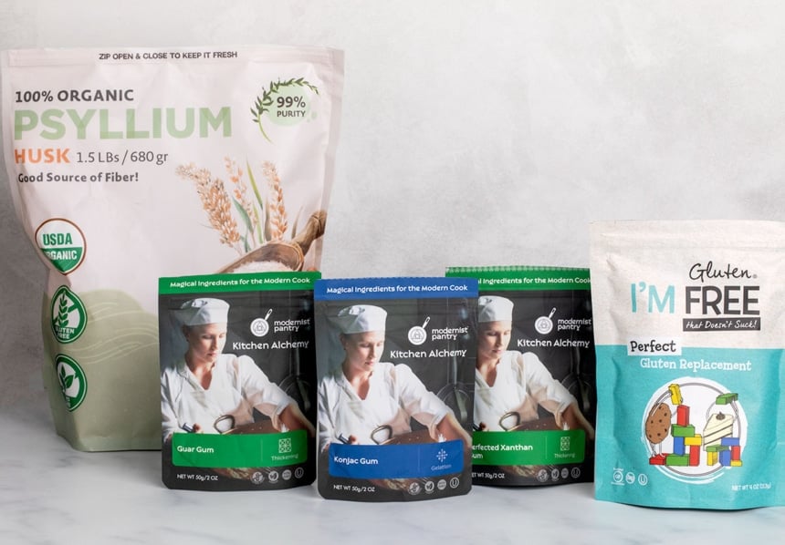 5 stand up plastic pouches containing xanthan gum and substitutes such as psyllium husk, guar gum, konjac powder, and perfect gluten replacement