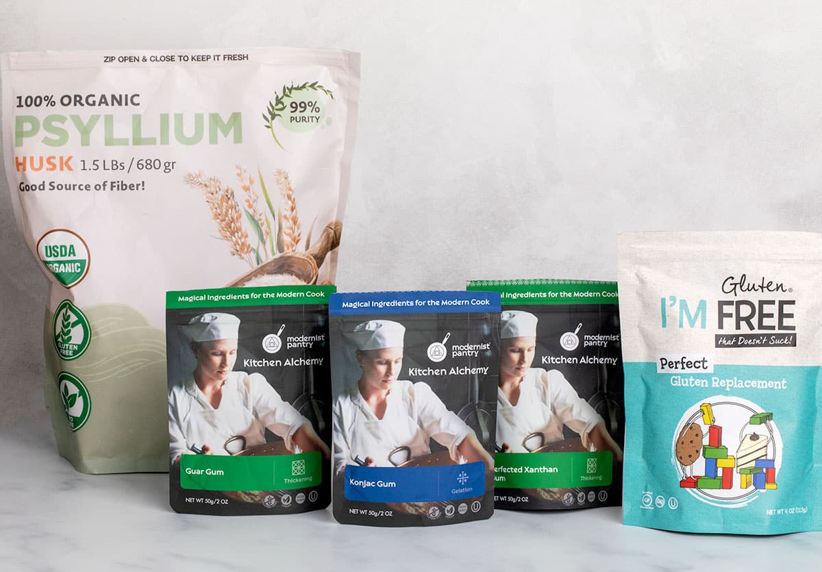 5 stand up plastic pouches containing xanthan gum and substitutes such as psyllium husk, guar gum, konjac powder, and perfect gluten replacement