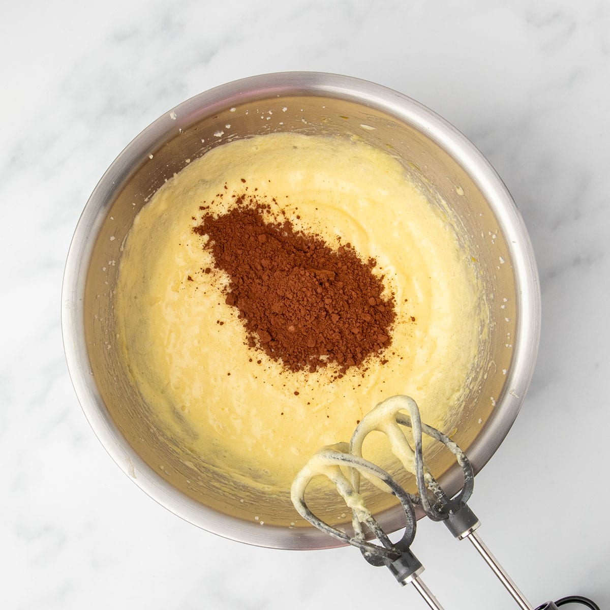 Rich cocoa powder sitting atop the pale batter, just before it’s mixed in