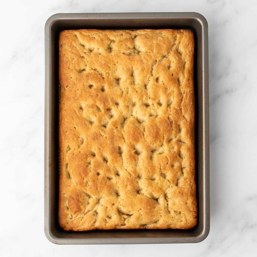 golden brown baked bread dough in baking pan