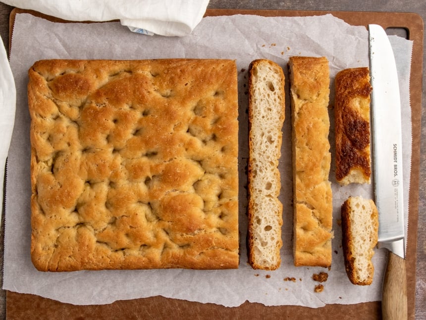 Rectangular golden brown bread sliced down the middle to reveal the airy, open crumb inside