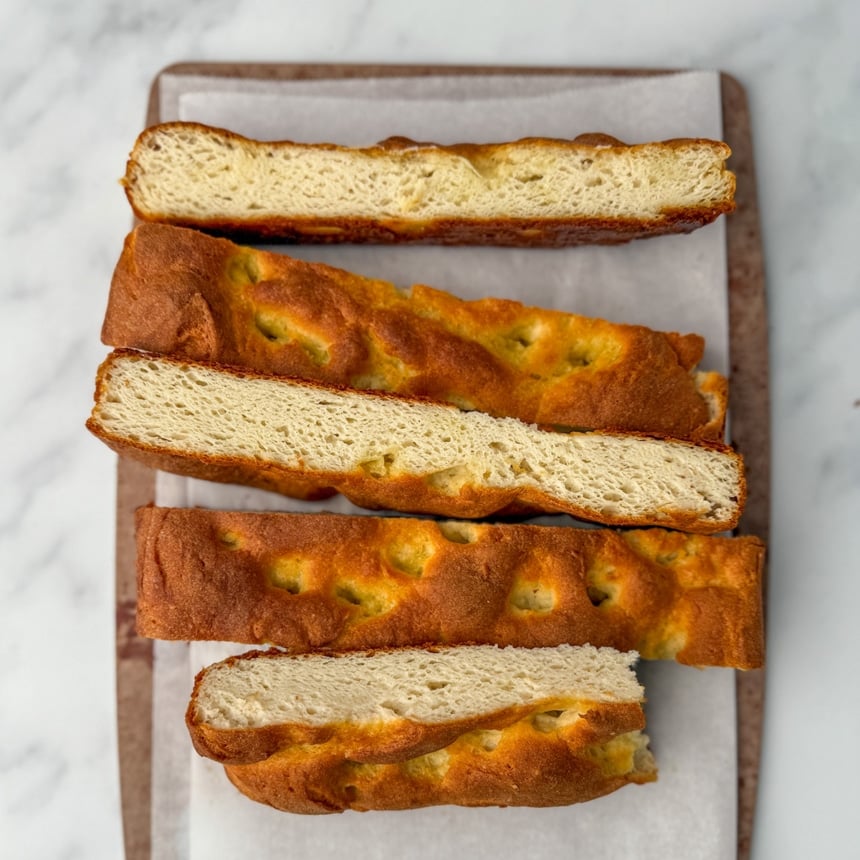 Loaf made with Gluten Free on a Shoestring bread flour blend, revealing an open, airy crumb and browned top.