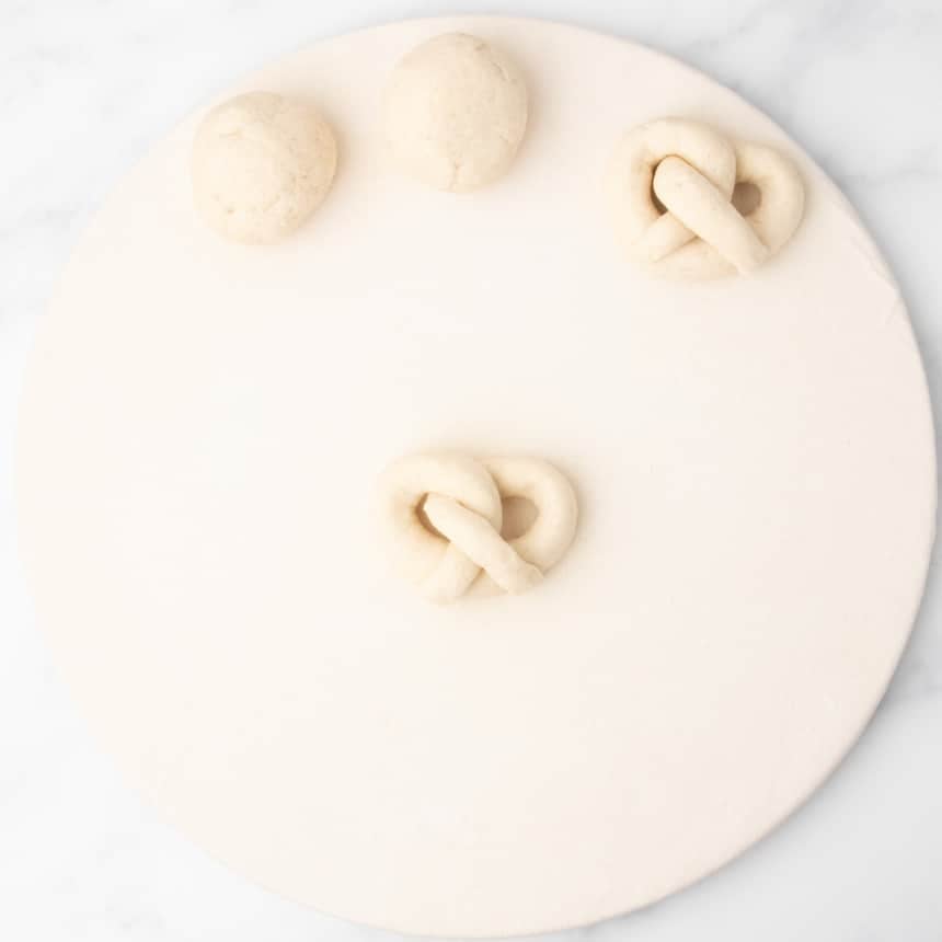 twisted rope of raw bread dough now in full pretzel shape
