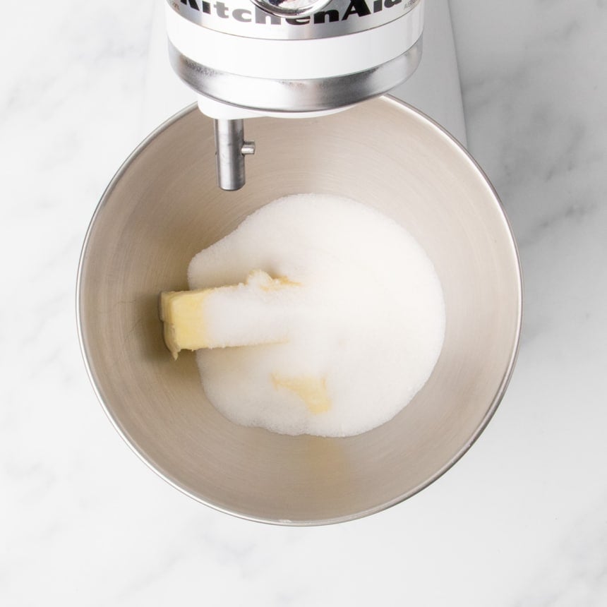 Butter and granulated sugar in a mixing bowl fitted to a stand mixer.