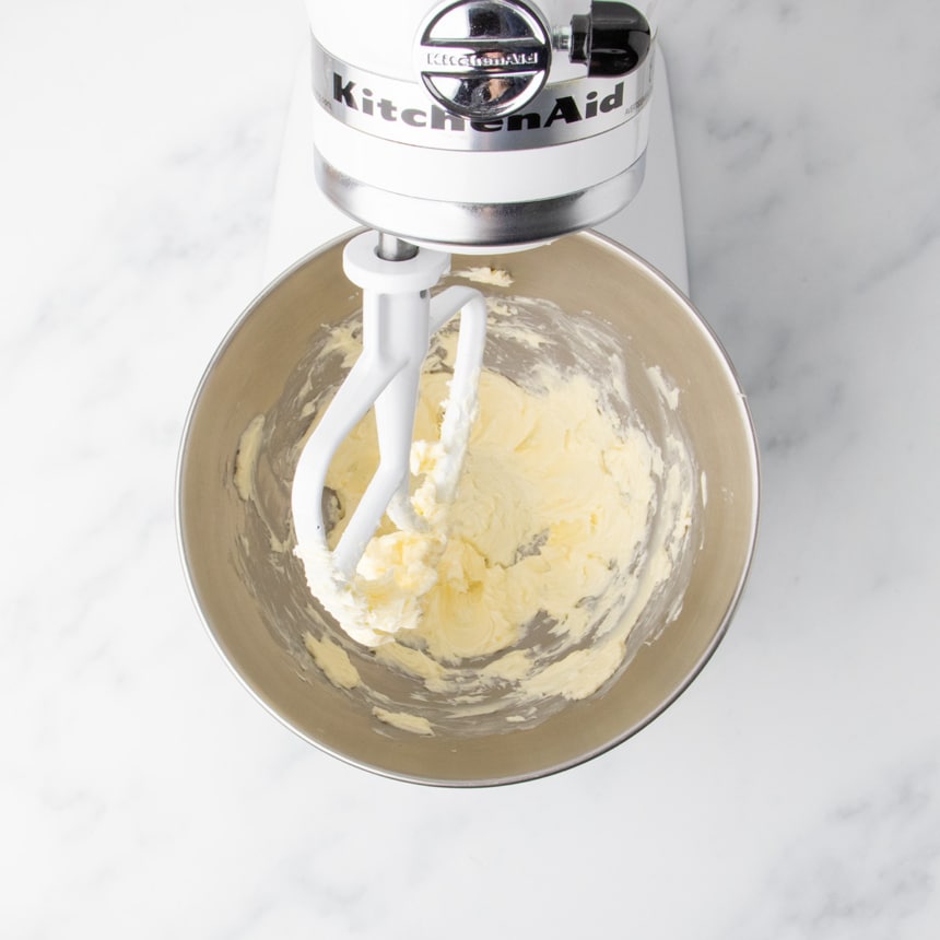 Room temperature butter partially creamed in the bowl of a stand mixer fitted with a paddle attachment.