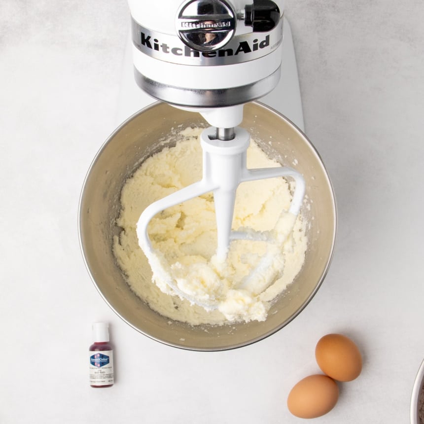 Butter and sugar creamed together in a stand mixer bowl with a paddle attachment.