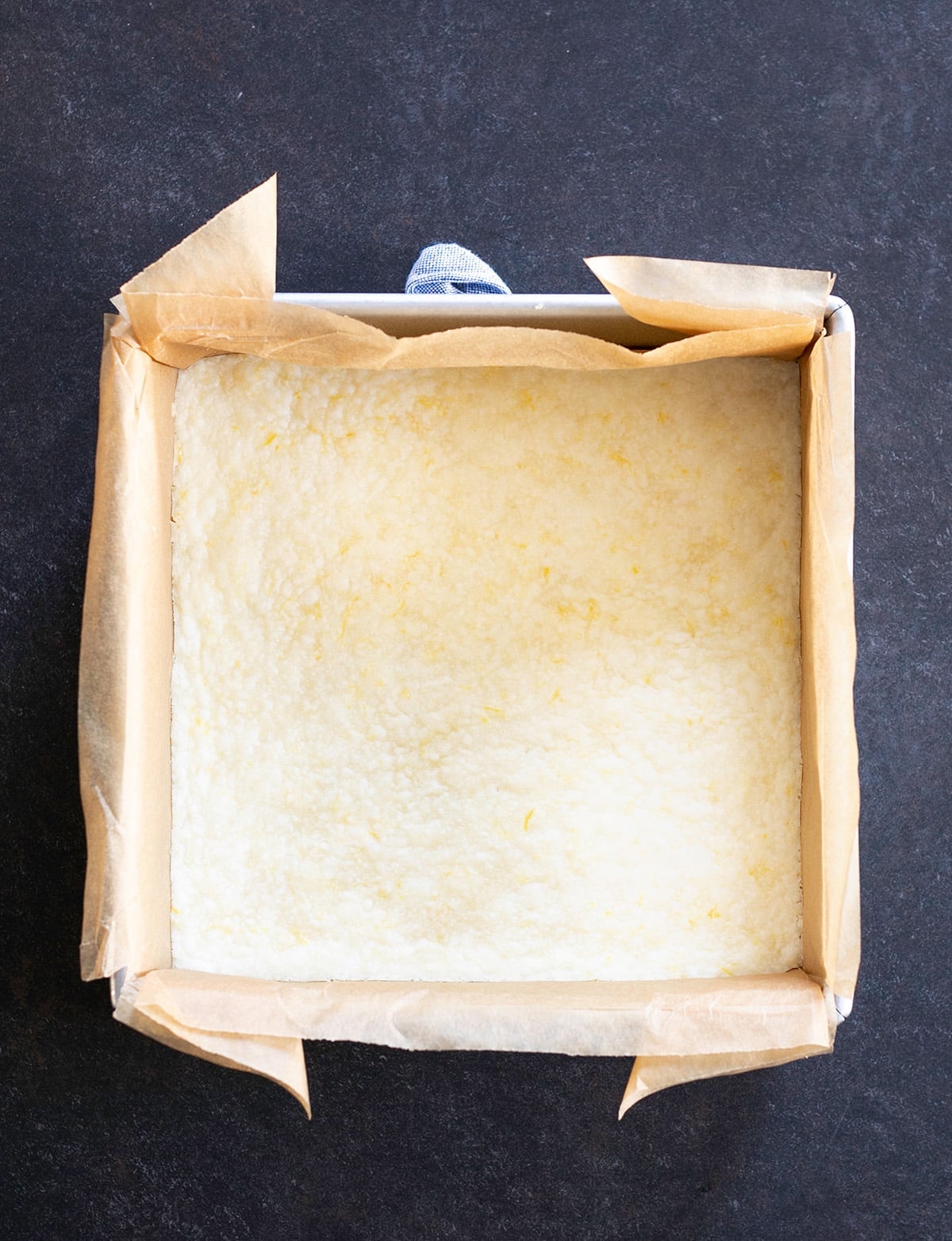 Overhead image of baked lemon crust in a square pan