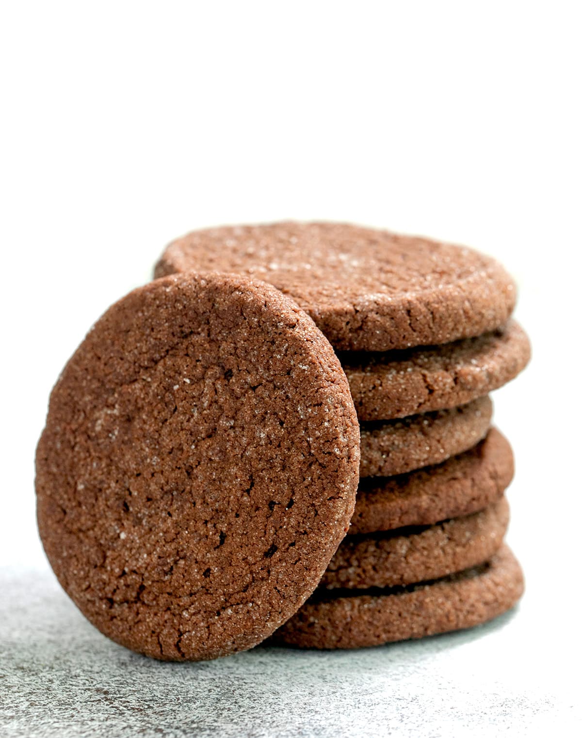 Soft chocolate cookies with sugar coating in stack with one on its side