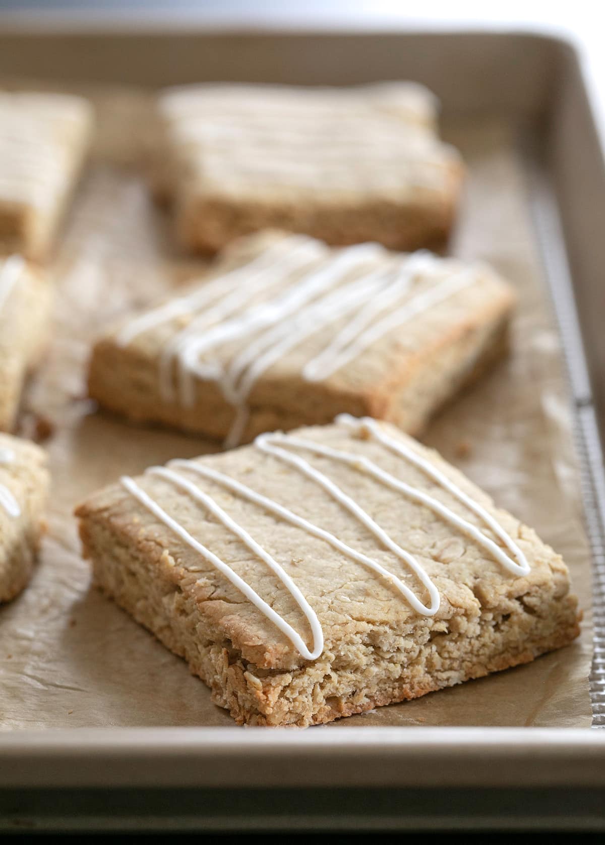 Oatmeal bars with icing drizzle on tray