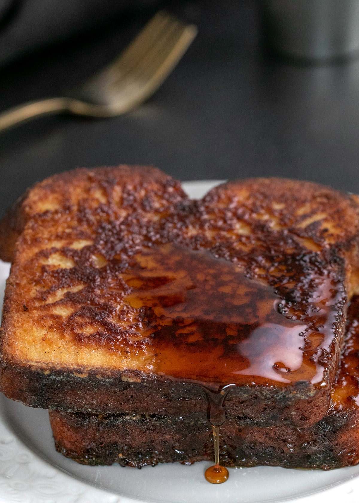 French Toast 2 slices on small white plate with some syrup