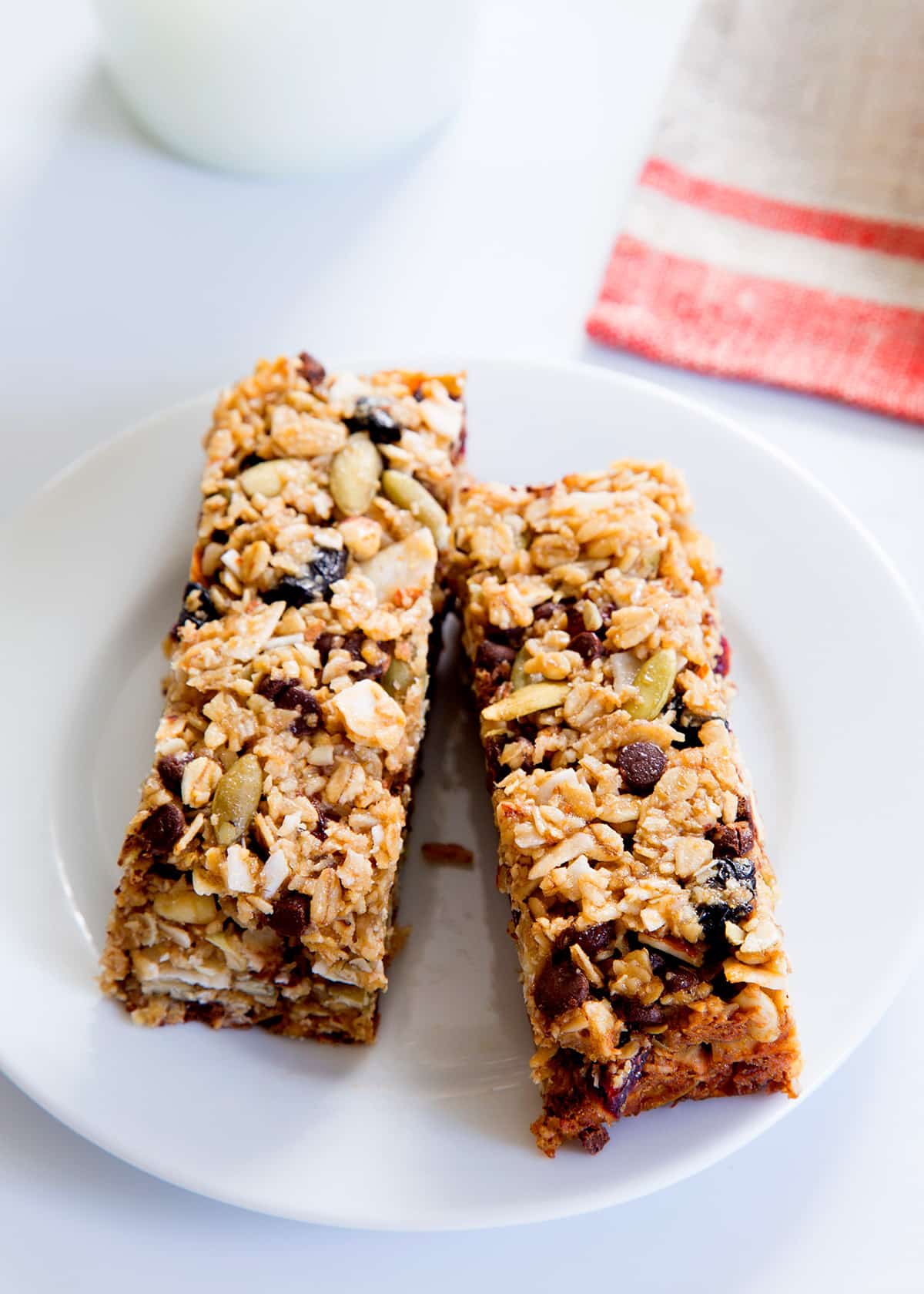 Overhead view of 2 granola bars on a white plate