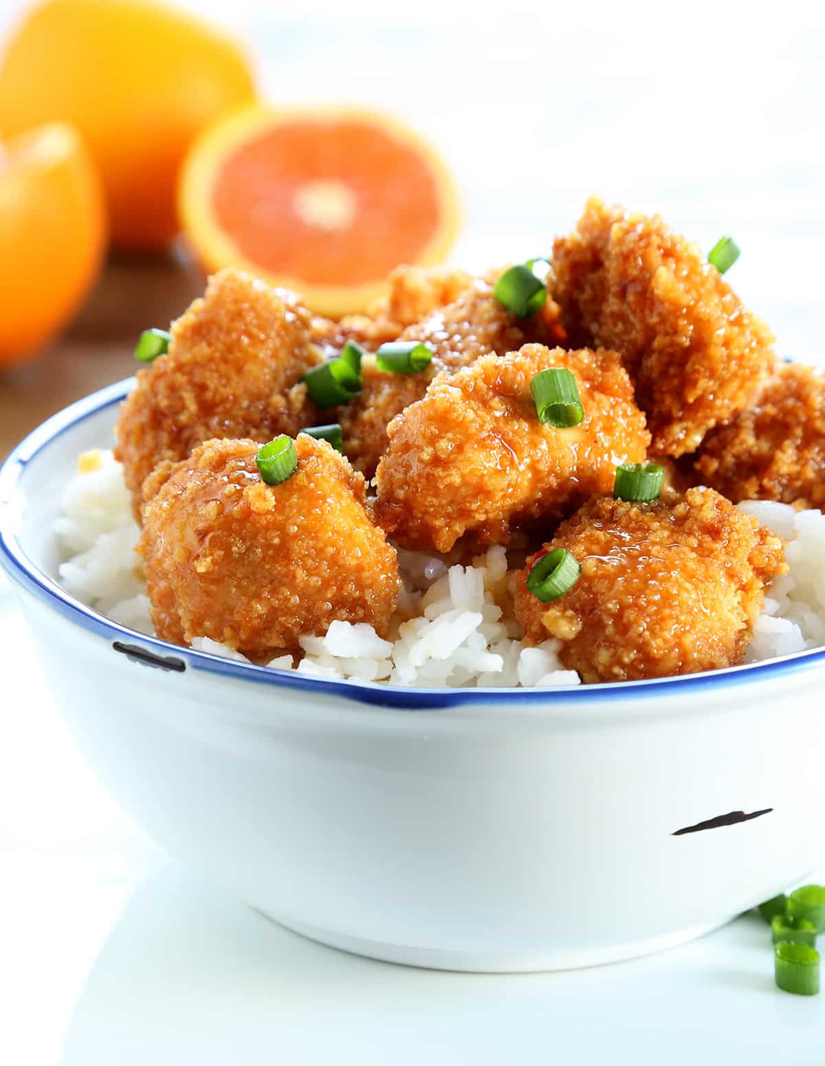 Chinese-style orange chicken with rice in a white bowl
