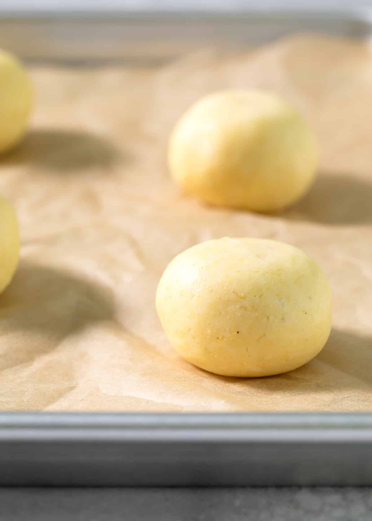 Raw balls of pan de bono on a tray