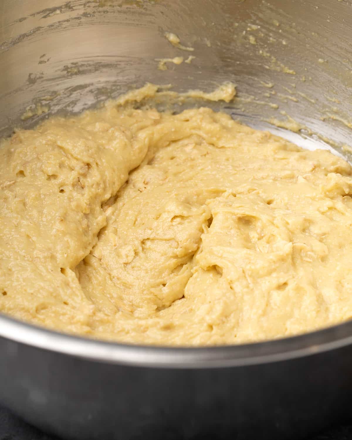 light tannish yellow oat bread batter in metal mixing bowl