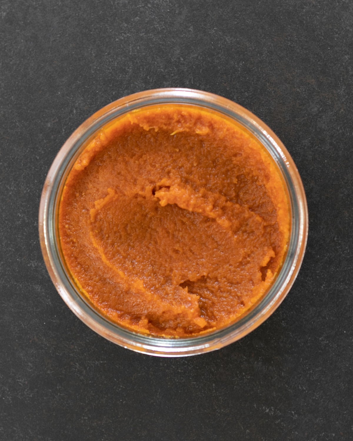 Pumpkin butter in glass jar overhead image