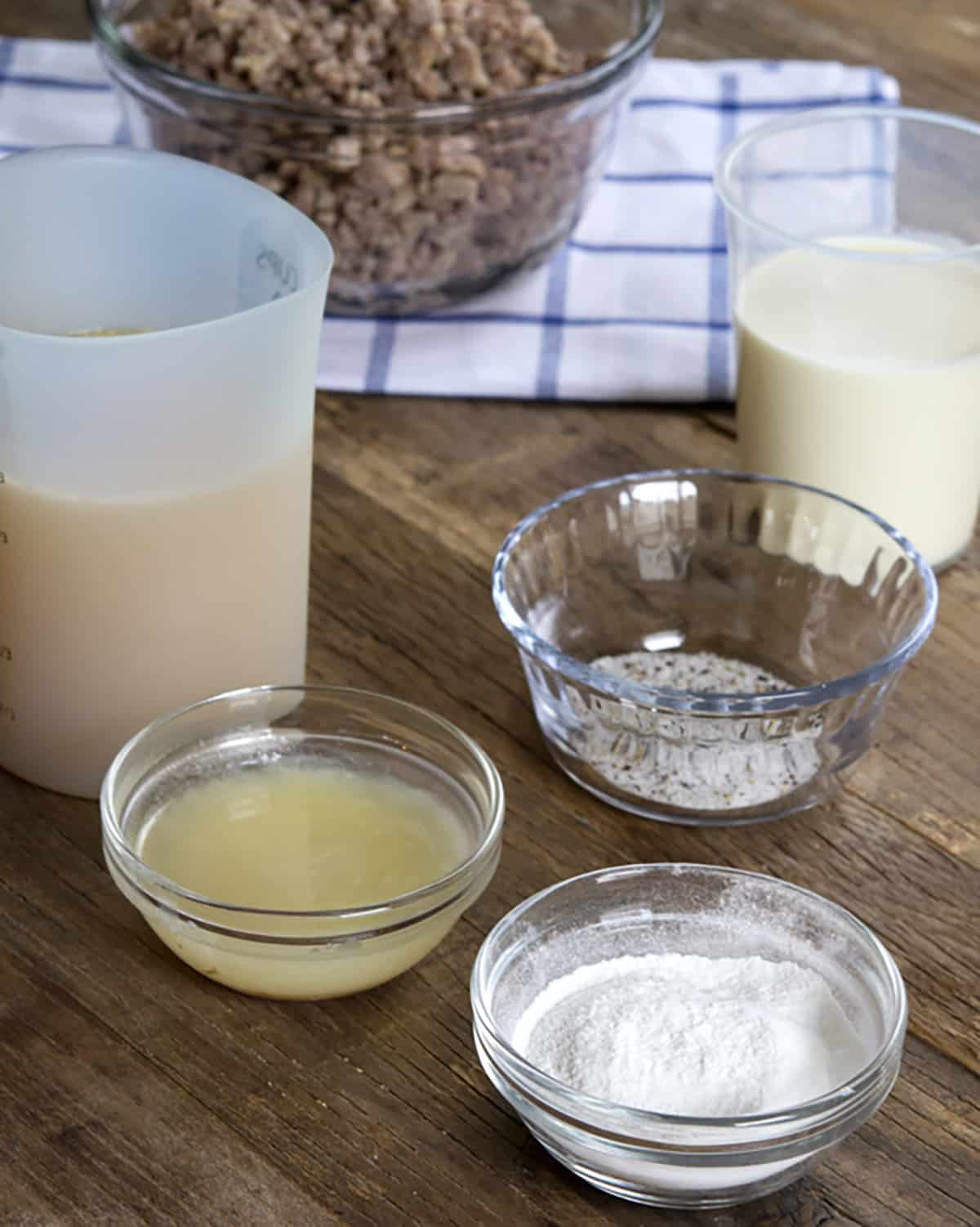 Gluten Free Biscuits and Gravy Bowls of ingredients on wooden surface.