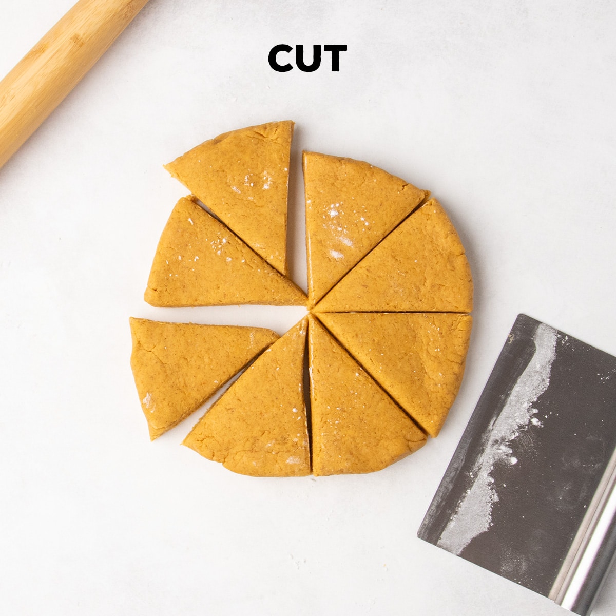 A round disk of orange dough is cut into eight triangular wedges beneath the word “CUT,” with a rolling pin and metal bench scraper beside it.