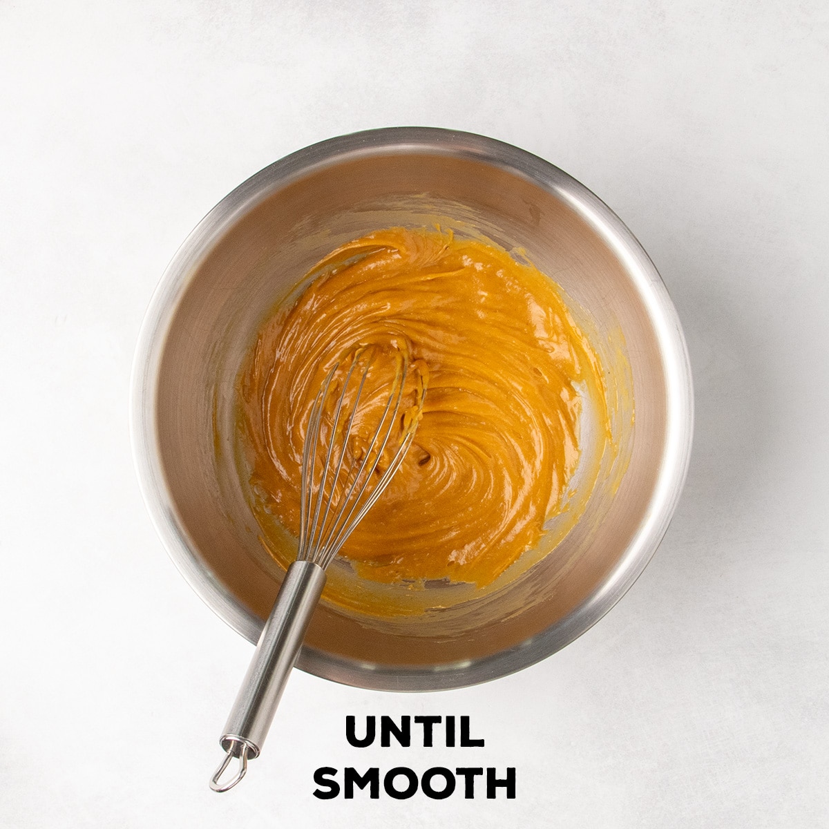 A smooth tan mixture fills the bottom of a metal bowl with a whisk resting inside; text reads “UNTIL SMOOTH.”